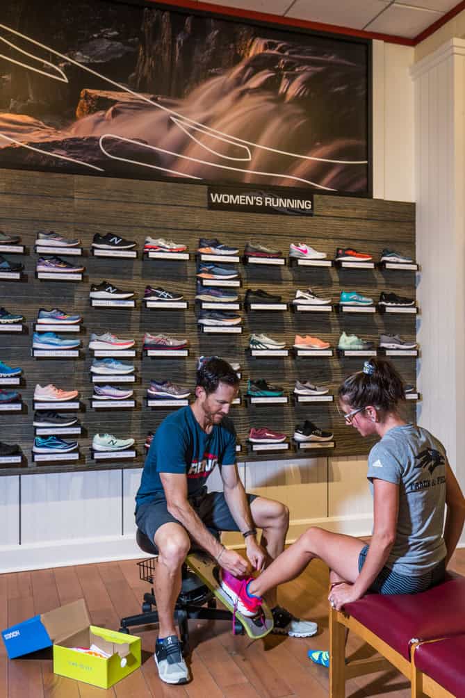 male staff member with ipad doing gait analysis